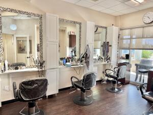 Interior of the Michael Jon beauty salon for sale in Boca Raton, FL, with styling chairs and ornate mirrors