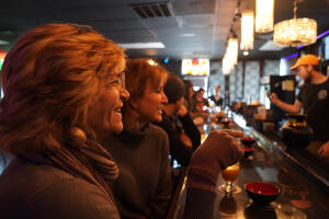 Guests at the bar inside Ohana Coffee & Kava, a food and beverage business for sale in Boynton Beach, FL
