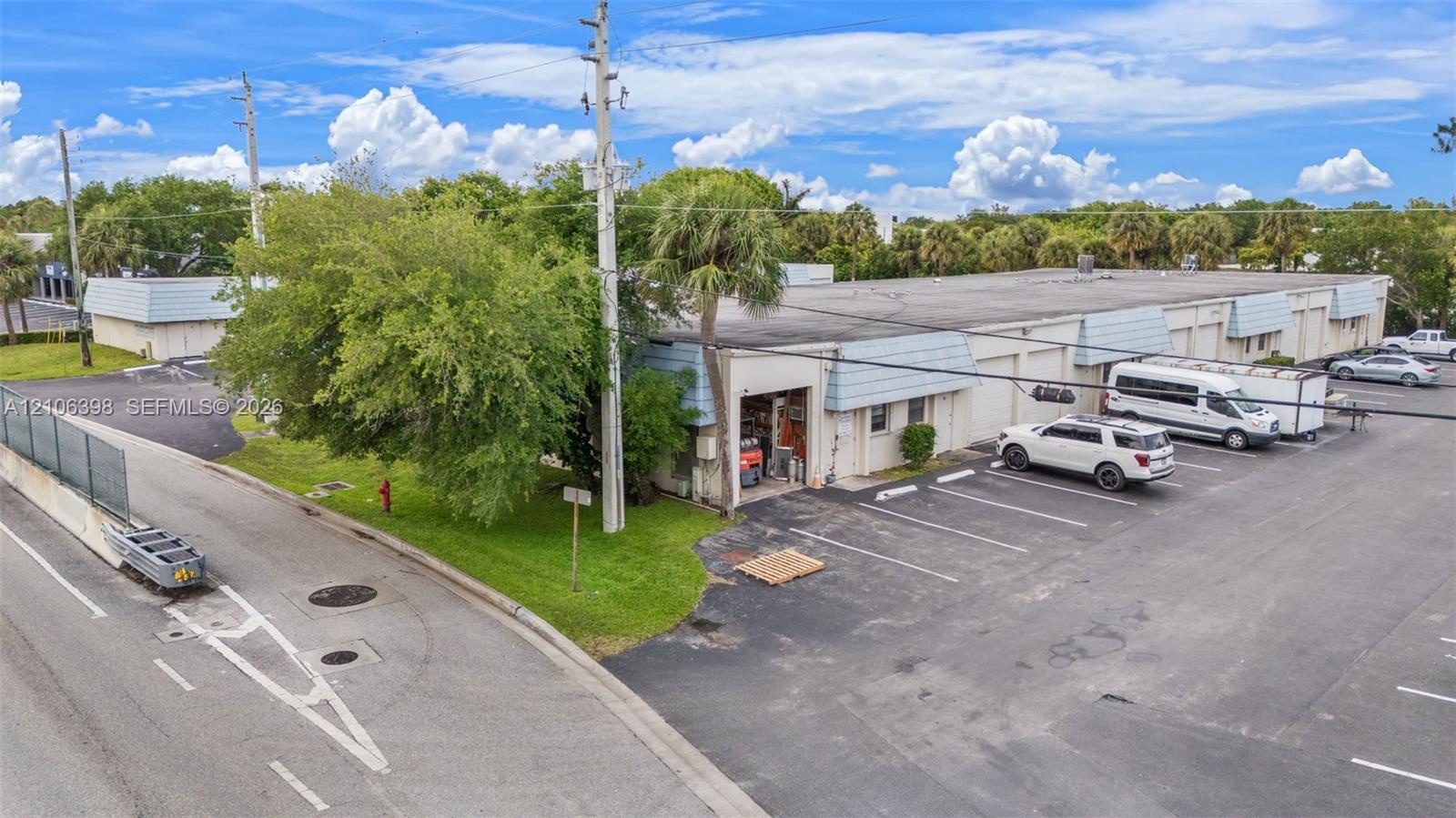 Warehouse building for sale at 3905 Investment Lane 16, West Palm Beach, FL, with roll-up bays and front parking