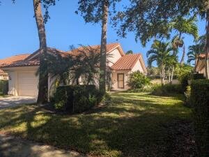 Single-family home for sale at 10523 Copper Lake Drive, Boynton Beach, FL 33437, with a tile roof and palm trees