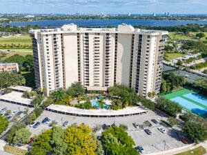 Aerial view of the condominium building at 2480 Presidential Way, West Palm Beach, FL, with pool and tennis courts